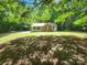 Charming one-story home nestled among mature trees with a brick archway above the front window at 4409 Homestead Rd, Rock Hill, SC 29732