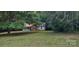 Charming one-story home with brick and siding exterior partially obscured by mature trees and shade at 4409 Homestead Rd, Rock Hill, SC 29732
