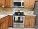 Another angle of the kitchen featuring stainless steel appliances, light countertops and wooden cabinets at 4409 Homestead Rd, Rock Hill, SC 29732