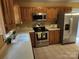 Well-equipped kitchen featuring stainless steel appliances, wooden cabinets, and white countertops at 4409 Homestead Rd, Rock Hill, SC 29732