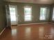 Spacious living room featuring hardwood floors, a neutral color palette, and an open doorway at 4409 Homestead Rd, Rock Hill, SC 29732
