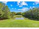 Backyard with a lake and trees beyond the grass at 458 Inverness Pl, Rock Hill, SC 29730