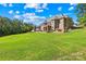 Sprawling backyard with lush grass and view of the home and lake at 458 Inverness Pl, Rock Hill, SC 29730
