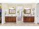 Dual vanity bathroom featuring framed mirrors, tile floors, and abundant cabinet space at 458 Inverness Pl, Rock Hill, SC 29730