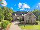Beautiful brick home with a manicured front lawn and a long driveway leading to a welcoming entrance at 458 Inverness Pl, Rock Hill, SC 29730