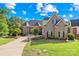 Charming brick home with a manicured lawn, mature trees, and a circular driveway providing curb appeal at 458 Inverness Pl, Rock Hill, SC 29730