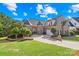 Charming brick home with a manicured lawn, mature trees, and a circular driveway offering plenty of curb appeal at 458 Inverness Pl, Rock Hill, SC 29730