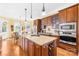 Modern kitchen features a large island with wine rack, stainless appliances and hardwood floors at 458 Inverness Pl, Rock Hill, SC 29730