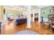 Open-concept living room with coffered ceilings, hardwood floors, and comfortable furnishings at 458 Inverness Pl, Rock Hill, SC 29730