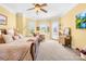 Large main bedroom with carpet flooring, a ceiling fan, bright windows and access to the bathroom at 458 Inverness Pl, Rock Hill, SC 29730