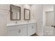 Bathroom with double sinks, framed mirrors and white cabinets at 4623 Harris Elliot Rd, Lincolnton, NC 28092