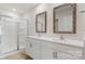 Bathroom with double sinks, framed mirrors, white cabinetry and a glass enclosed shower at 4623 Harris Elliot Rd, Lincolnton, NC 28092
