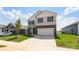 Charming two-story home with stone accents, gray siding, a well-manicured lawn, and attached two car garage at 4623 Harris Elliot Rd, Lincolnton, NC 28092