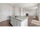 Bright, open concept featuring a kitchen island, stainless appliances, and a view into the living area at 4623 Harris Elliot Rd, Lincolnton, NC 28092