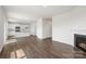 Open-concept living space with fireplace, new hardwood floors, and a view of the bright, modern kitchen at 4623 Harris Elliot Rd, Lincolnton, NC 28092