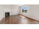 Light-filled living room with a cozy fireplace and hardwood floors creating a warm, inviting space at 4623 Harris Elliot Rd, Lincolnton, NC 28092