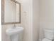Neutral powder room offering a pedestal sink, decorative mirror, and comfort height toilet at 4623 Harris Elliot Rd, Lincolnton, NC 28092