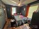 Comfortable bedroom with hardwood floors, ample natural light, and personal touches, creating a warm and inviting atmosphere at 506 Sycamore Ave, Gastonia, NC 28052