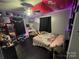 Stylish bedroom with dark accents, a vanity, and unique decorations, offering a trendy and comfortable living space at 506 Sycamore Ave, Gastonia, NC 28052