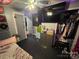 Cozy bedroom with a large TV, ample storage, and a well-organized closet, designed for comfortable living and relaxation at 506 Sycamore Ave, Gastonia, NC 28052