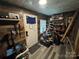 Wood paneled entryway featuring a door, window, decorations, and shelves, creating a rustic and functional space at 506 Sycamore Ave, Gastonia, NC 28052