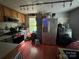 Functional kitchen with stainless steel appliances, wood cabinets, and a window offering natural light, ready for culinary adventures at 506 Sycamore Ave, Gastonia, NC 28052