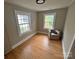 Inviting bedroom features hardwood floors and natural light from two windows, and a chair at 520 Margaret Dr, Statesville, NC 28677