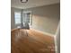 A well-lit bedroom featuring hardwood floors, two windows, and a table for functionality at 520 Margaret Dr, Statesville, NC 28677