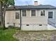 Back of house with updated gray vinyl siding, windows, and stairs at 520 Margaret Dr, Statesville, NC 28677
