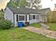 A charming single-story home with black shutters, a front yard, and walkway, offering classic curb appeal at 520 Margaret Dr, Statesville, NC 28677