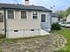Back exterior showcasing updated vinyl siding, windows, and access to a small set of stairs at 520 Margaret Dr, Statesville, NC 28677