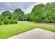 Large backyard with mature trees and a partial wooden fence at 5305 Friendly Baptist Church Rd, Indian Trail, NC 28079