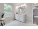 Bathroom featuring white marble floors, a large mirror, and lots of natural light at 5305 Friendly Baptist Church Rd, Indian Trail, NC 28079