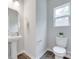 Half bathroom with pedestal sink, toilet, and a window providing natural light at 5305 Friendly Baptist Church Rd, Indian Trail, NC 28079