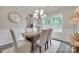 Elegant dining room featuring a modern chandelier, a large window, and neutral-toned decor at 5305 Friendly Baptist Church Rd, Indian Trail, NC 28079
