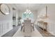 Elegant dining room featuring a modern chandelier, a large window, and neutral-toned decor at 5305 Friendly Baptist Church Rd, Indian Trail, NC 28079