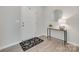 Bright foyer with wood flooring, a modern accent table, a round mirror, and a black and white patterned rug at 5305 Friendly Baptist Church Rd, Indian Trail, NC 28079