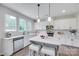 Bright kitchen features white cabinets, stainless steel appliances, and a marble island with pendant lighting at 5305 Friendly Baptist Church Rd, Indian Trail, NC 28079