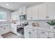 Bright kitchen featuring stainless steel appliances, white cabinets, and marble countertops at 5305 Friendly Baptist Church Rd, Indian Trail, NC 28079
