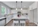 Modern kitchen featuring a central island with seating, pendant lighting, and white cabinets at 5305 Friendly Baptist Church Rd, Indian Trail, NC 28079