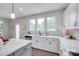 Well-lit kitchen area with stainless steel appliances, white cabinets, marble countertops, and a large window at 5305 Friendly Baptist Church Rd, Indian Trail, NC 28079