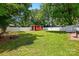 Lush backyard with well-maintained lawn, fenced perimeter and a charming red shed at 604 Meadowbrook Rd, Kings Mountain, NC 28086