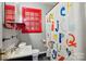 A full bathroom featuring a colorful shower curtain and red trim window at 604 Meadowbrook Rd, Kings Mountain, NC 28086