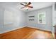 A well-lit bedroom with two windows, hardwood flooring, and minimalist floating shelves at 604 Meadowbrook Rd, Kings Mountain, NC 28086