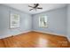 Bright bedroom with hardwood floors, ample natural light, and a ceiling fan at 604 Meadowbrook Rd, Kings Mountain, NC 28086