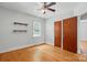 A bedroom with hardwood floors, a ceiling fan, and convenient built-in closet storage at 604 Meadowbrook Rd, Kings Mountain, NC 28086