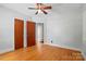 A bedroom with hardwood floors, a ceiling fan, and dual closets at 604 Meadowbrook Rd, Kings Mountain, NC 28086