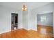 Dining room with hardwood floors, light fixture, and an entrance to another room at 604 Meadowbrook Rd, Kings Mountain, NC 28086