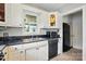 Modern kitchen featuring white cabinetry, black appliances, and convenient layout at 604 Meadowbrook Rd, Kings Mountain, NC 28086