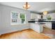 Eat-in kitchen featuring white cabinets, dark countertops, a window, and hardwood floors at 604 Meadowbrook Rd, Kings Mountain, NC 28086